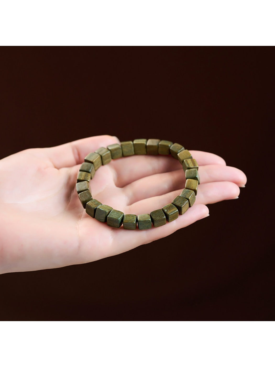 Stacked view of Emora green beaded bracelet with other bracelets