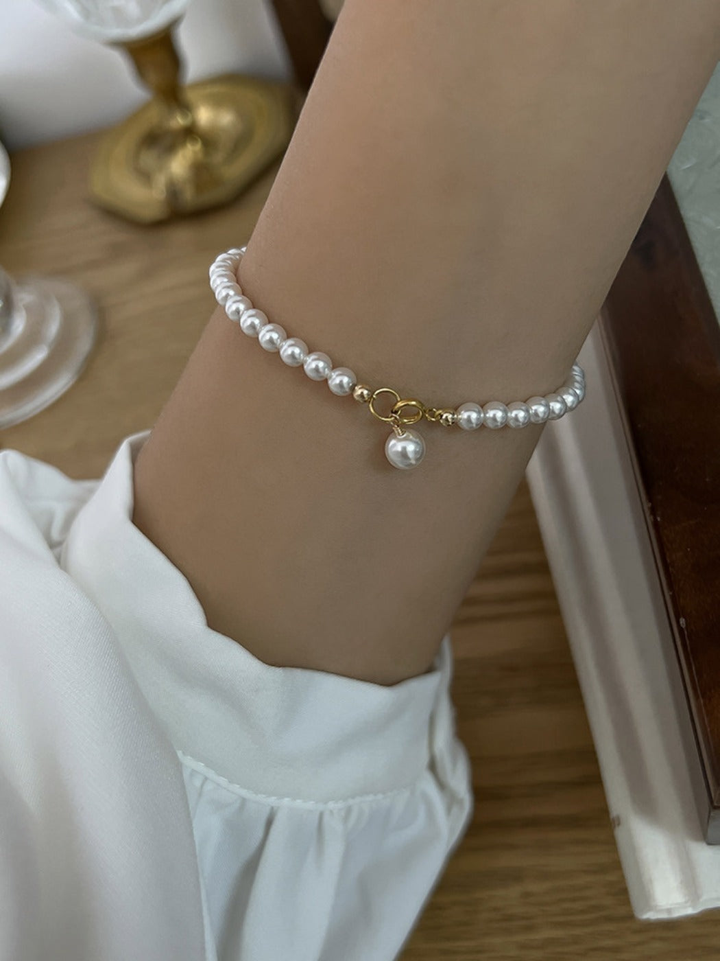 Emora pearl bracelet with tiny beads displayed alongside matching jewelry pieces
