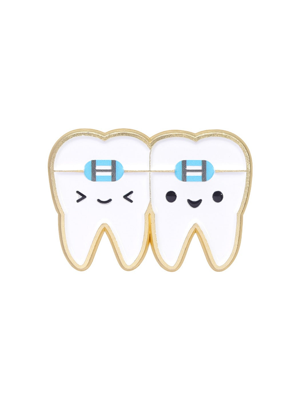 Pinori dental brooch photographed with a blurred dental office background