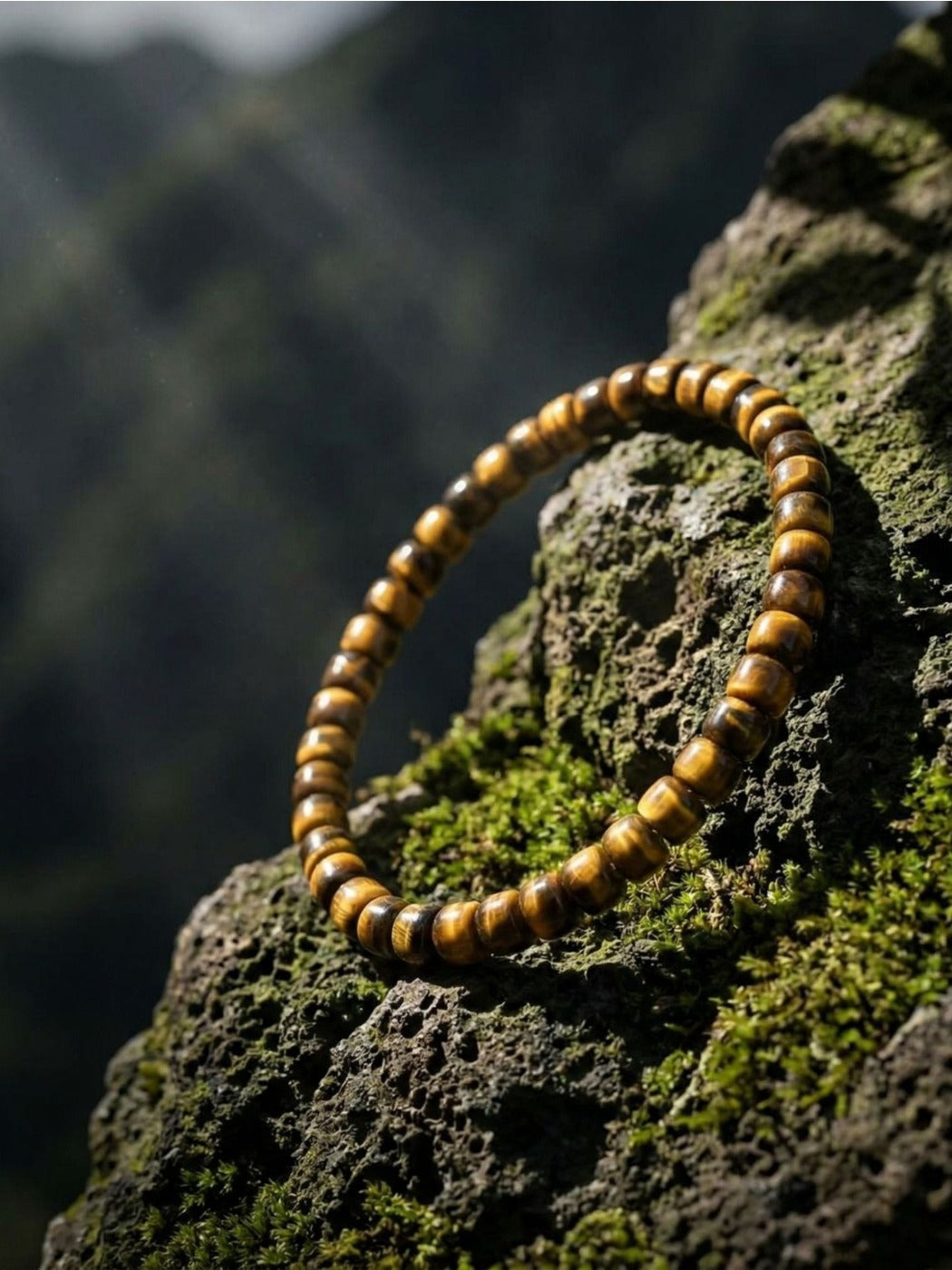 Side view of Emora unisex bracelet highlighting the round tiger eye beads and elastic band