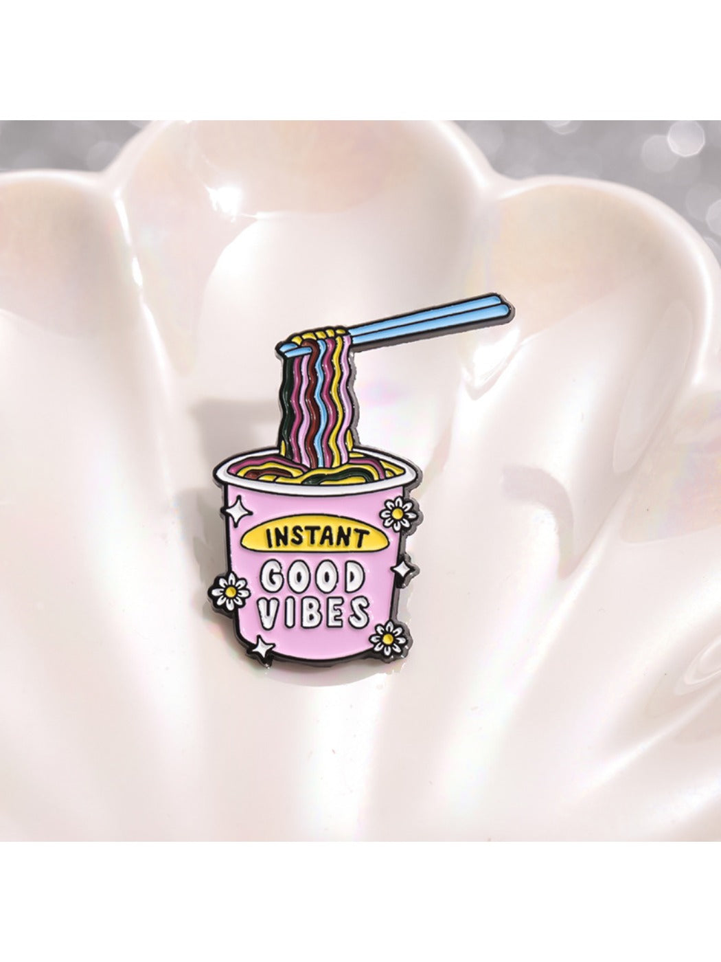 Close-up of Pinori instant noodle ramen brooch pin with detailed noodle and chopstick design
