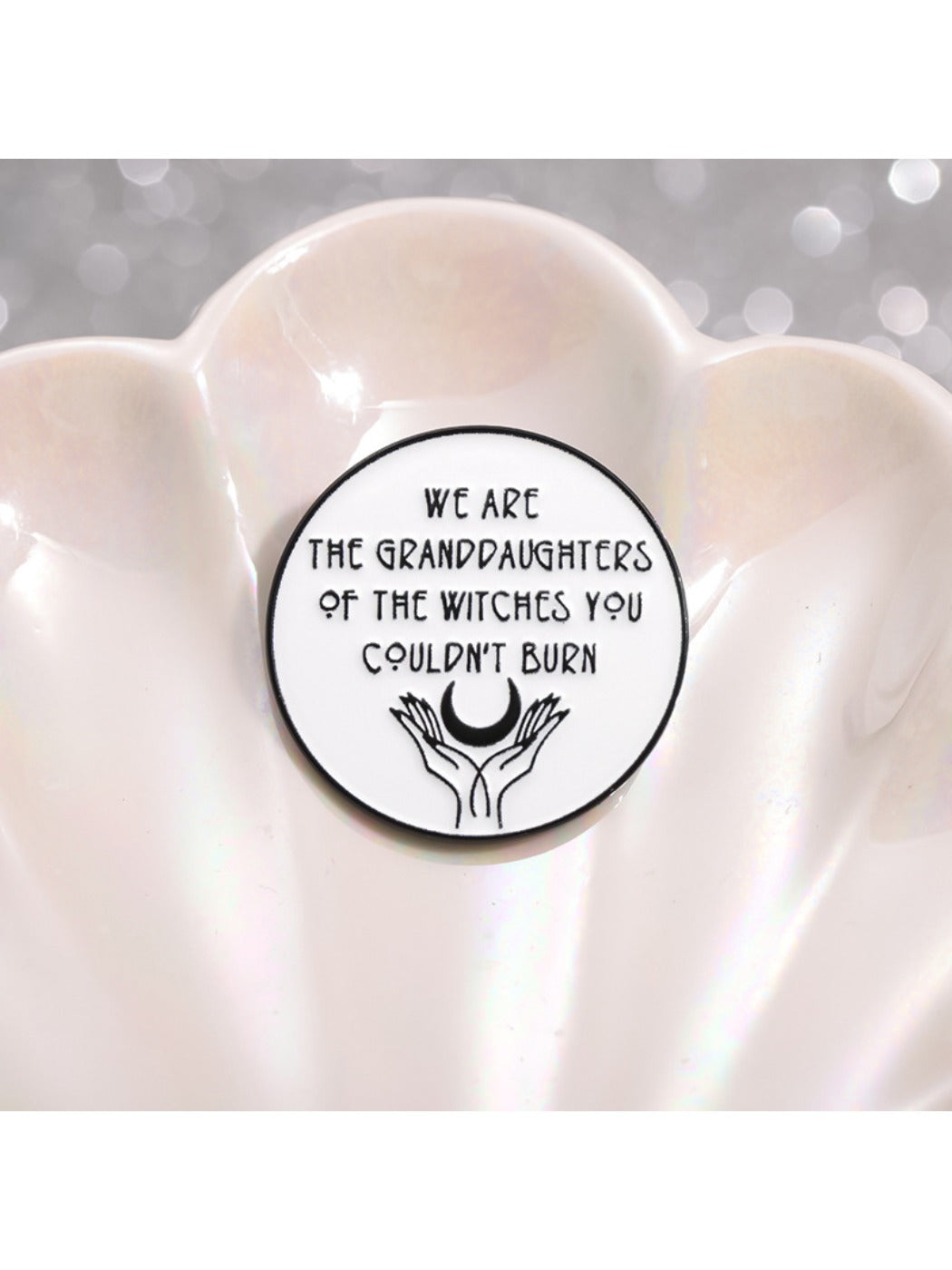 Badge pin featuring Girl Power Unburnable text with flame graphic in pink and gold