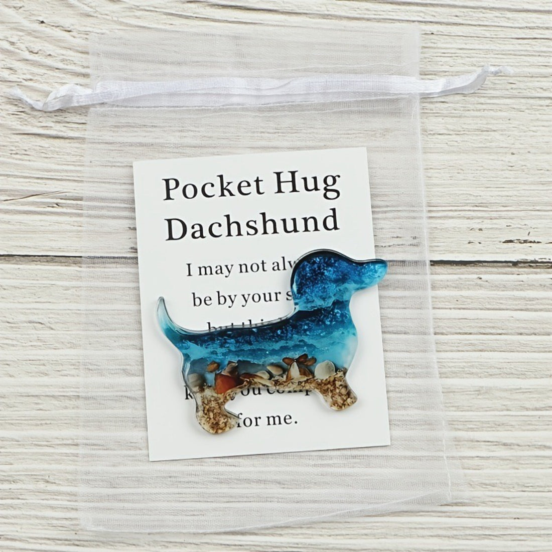 Taphug Little Dachshund Pocket Hug plush with a small tag attached on the side