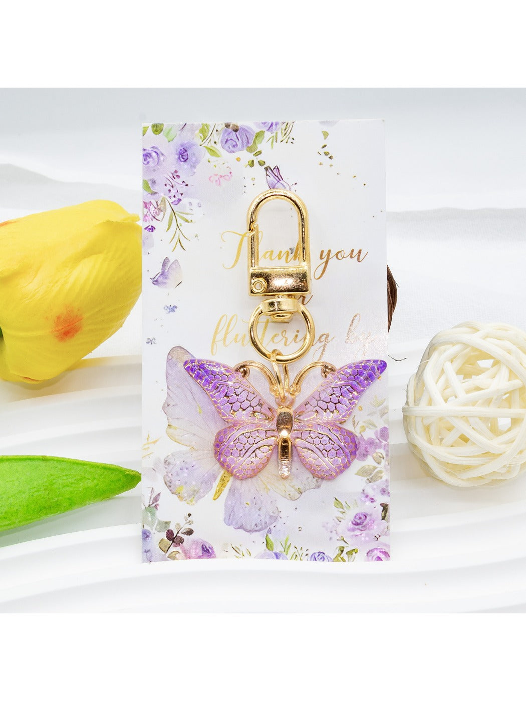 Taphug acrylic keychain featuring a butterfly design with gradient colors