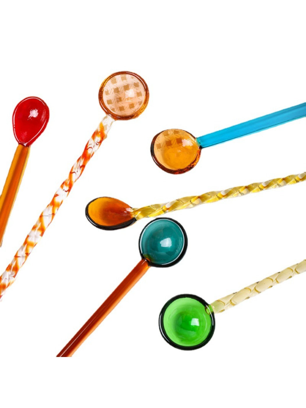 Thimara glass spoon with colorful transparent design resting on a white plate