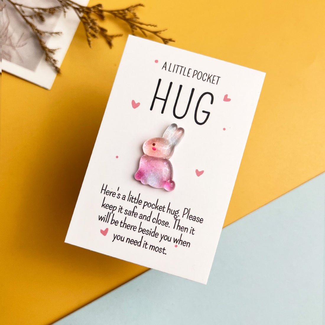 Taphug Glitter Bunny Pocket Hug held in hand to show compact size and pocket fit