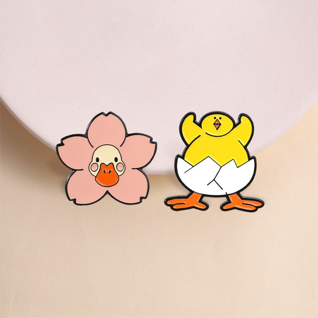 Pinori - Playful Duck and Flower Motif Pin