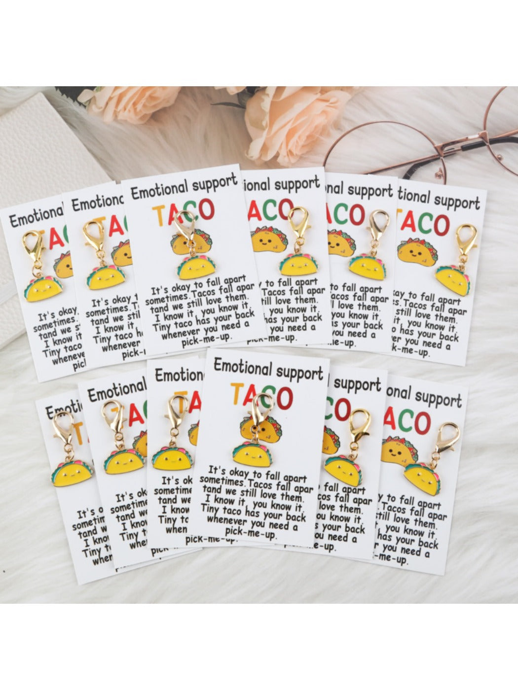 Close-up of a taco keychain with greeting card partially visible