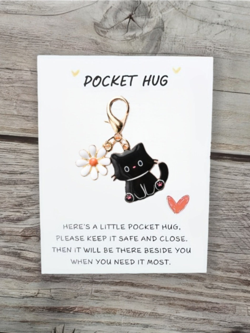 Taphug Pocket Hug keychain with cartoon cat charm isolated on a plain background
