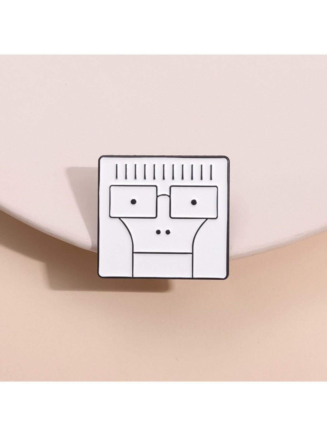 White minimalist cartoon character pin with black outline on a plain background