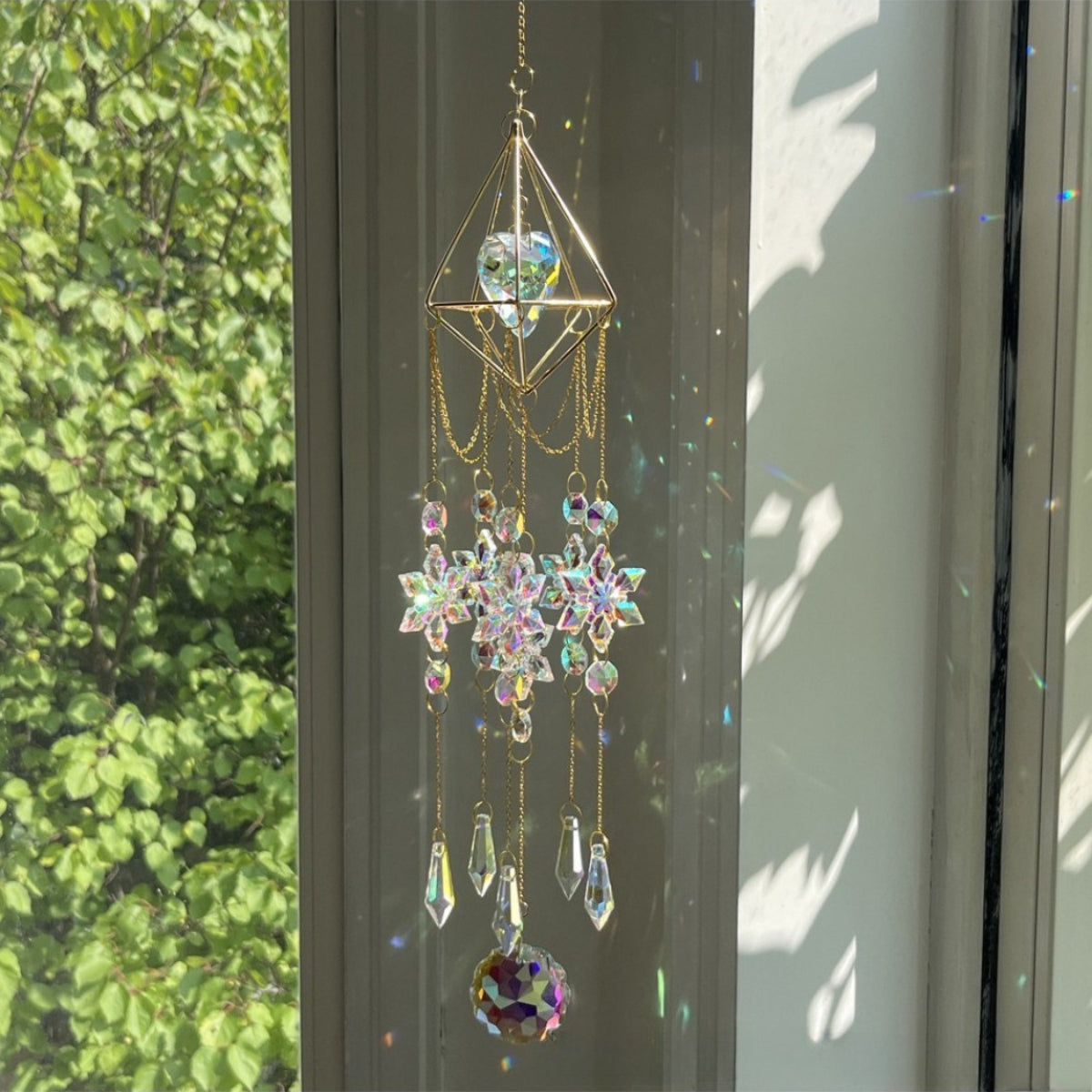Somnira Snowflake Prism Suncatcher hanging in natural light highlighting prism colors