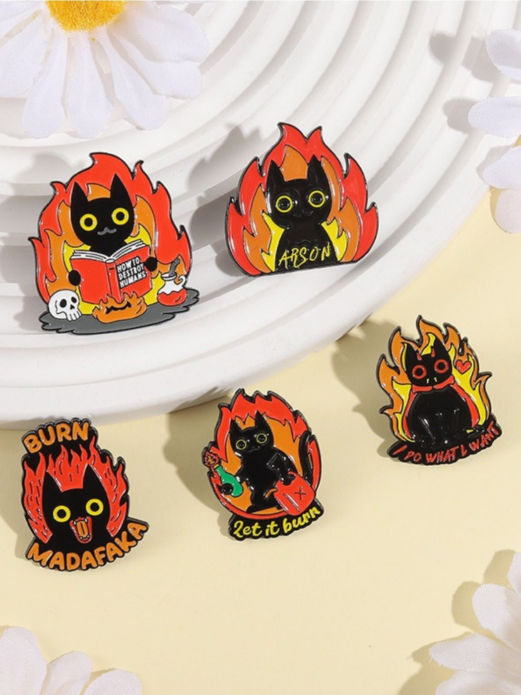 Pinori cartoon black cat badge displayed on a denim jacket