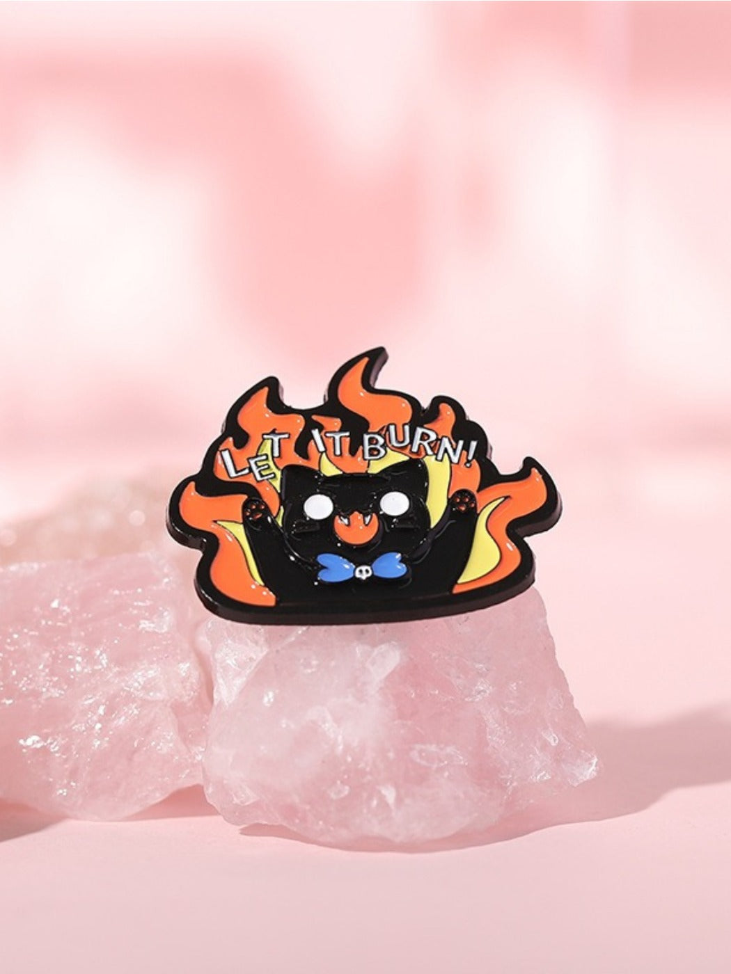 Close-up of Pinori Evil Kitten brooch showing vibrant orange and red flames