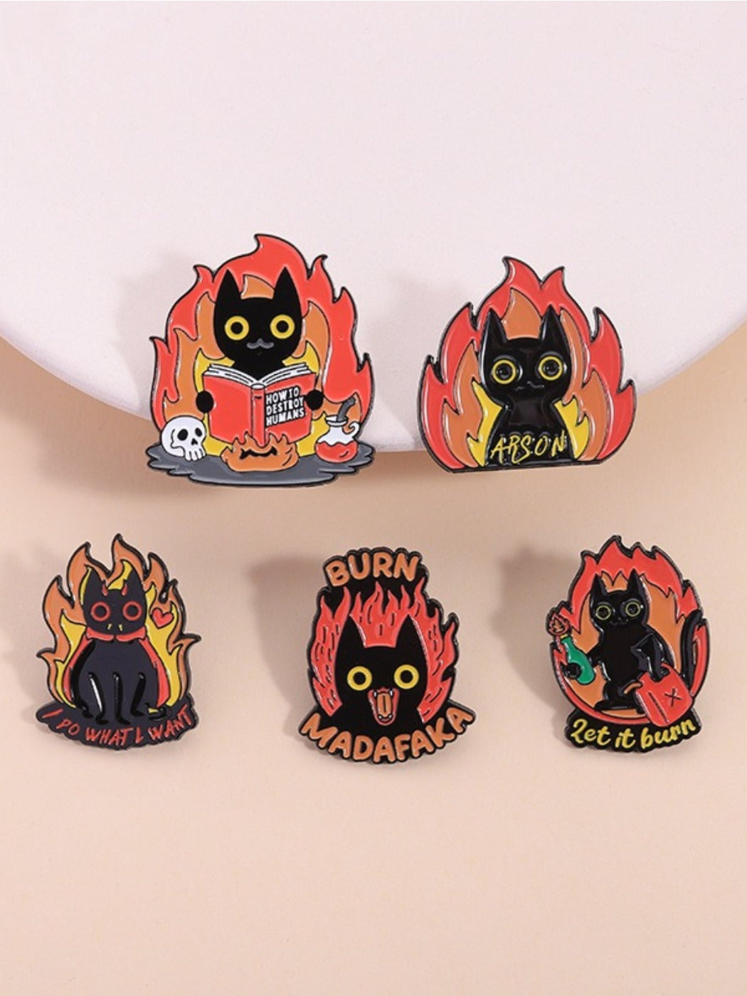 Pinori black cat enamel badge with flame design on white background