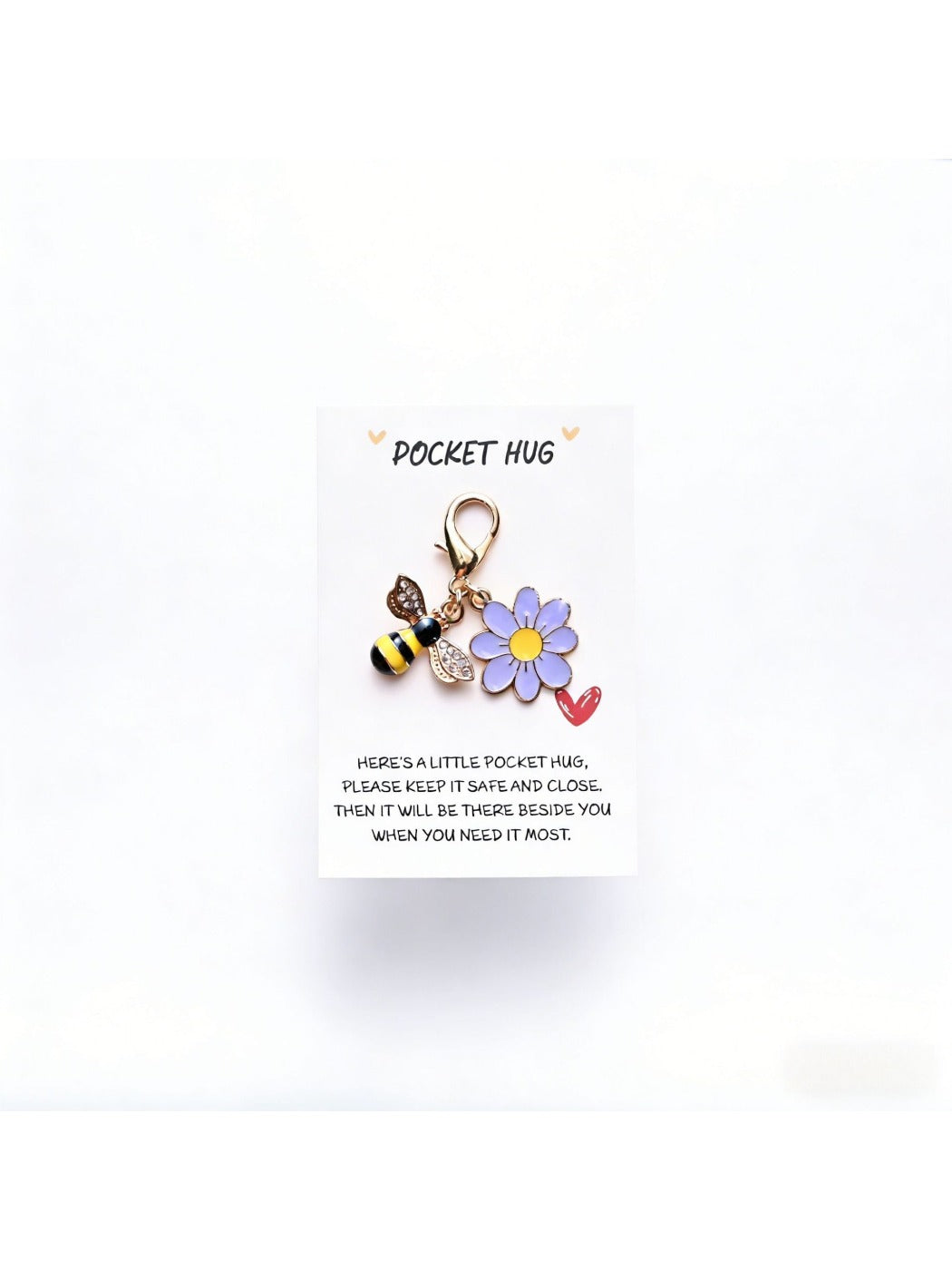 Taphug Pocket Hug Daisy Keychain with daisy charm placed next to a smartphone