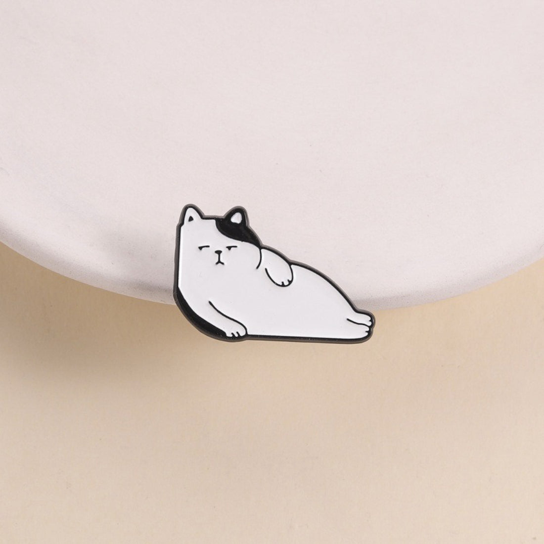 Pinori Lazy Cat Lounge enamel pin showing a relaxed cat lying down with soft pastel colors