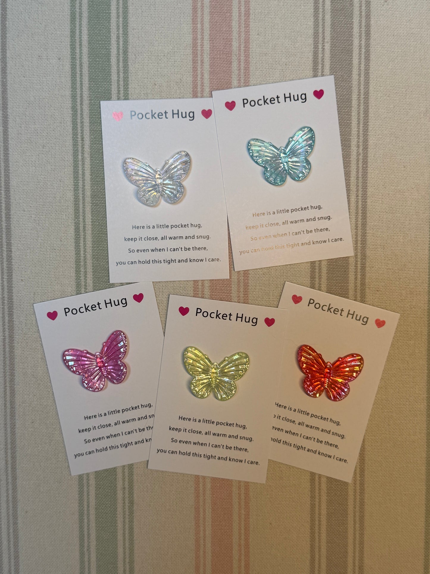 Taphug Pocket Hug card and butterfly token laid flat on a white background