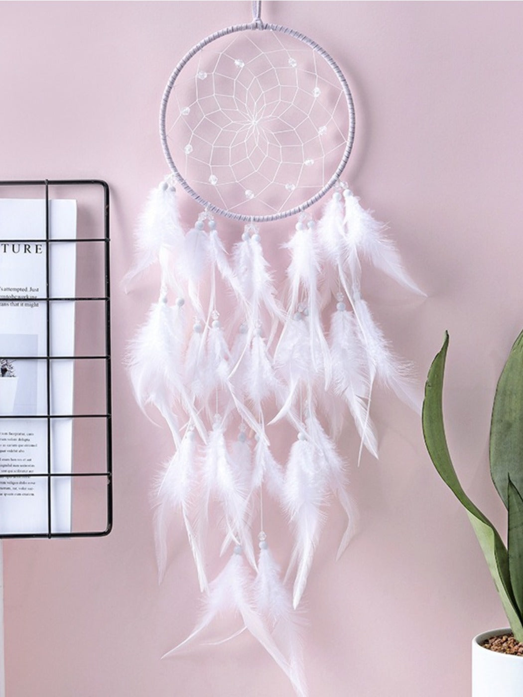 Somnira Native American dreamcatcher wind chime with feathers and beads hanging outdoors