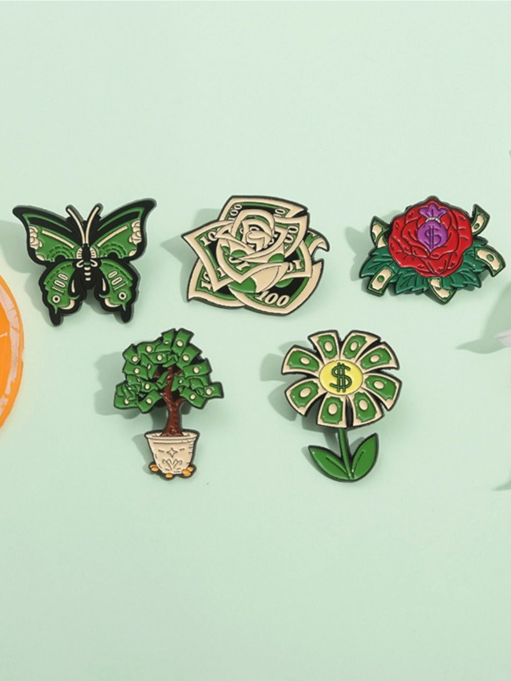 Close-up of Pinori four leaf clover brooch showing detailed flower pattern and glossy finish