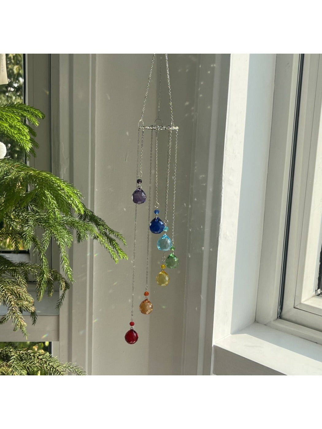 Close-up of the Life Tree design on the wooden ring of the Somnira seven color crystal wind chime