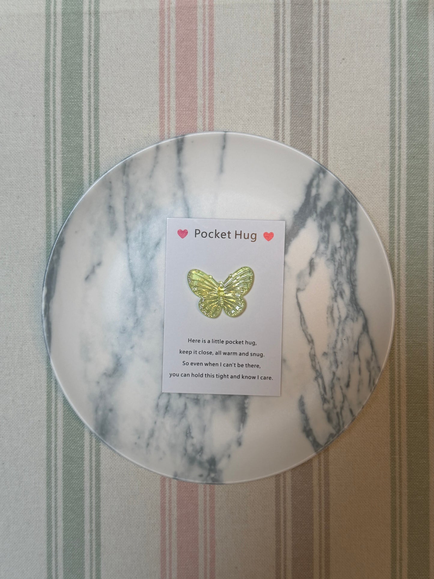 Stack of Taphug Pocket Hug cards highlighting the butterfly motif and compact size