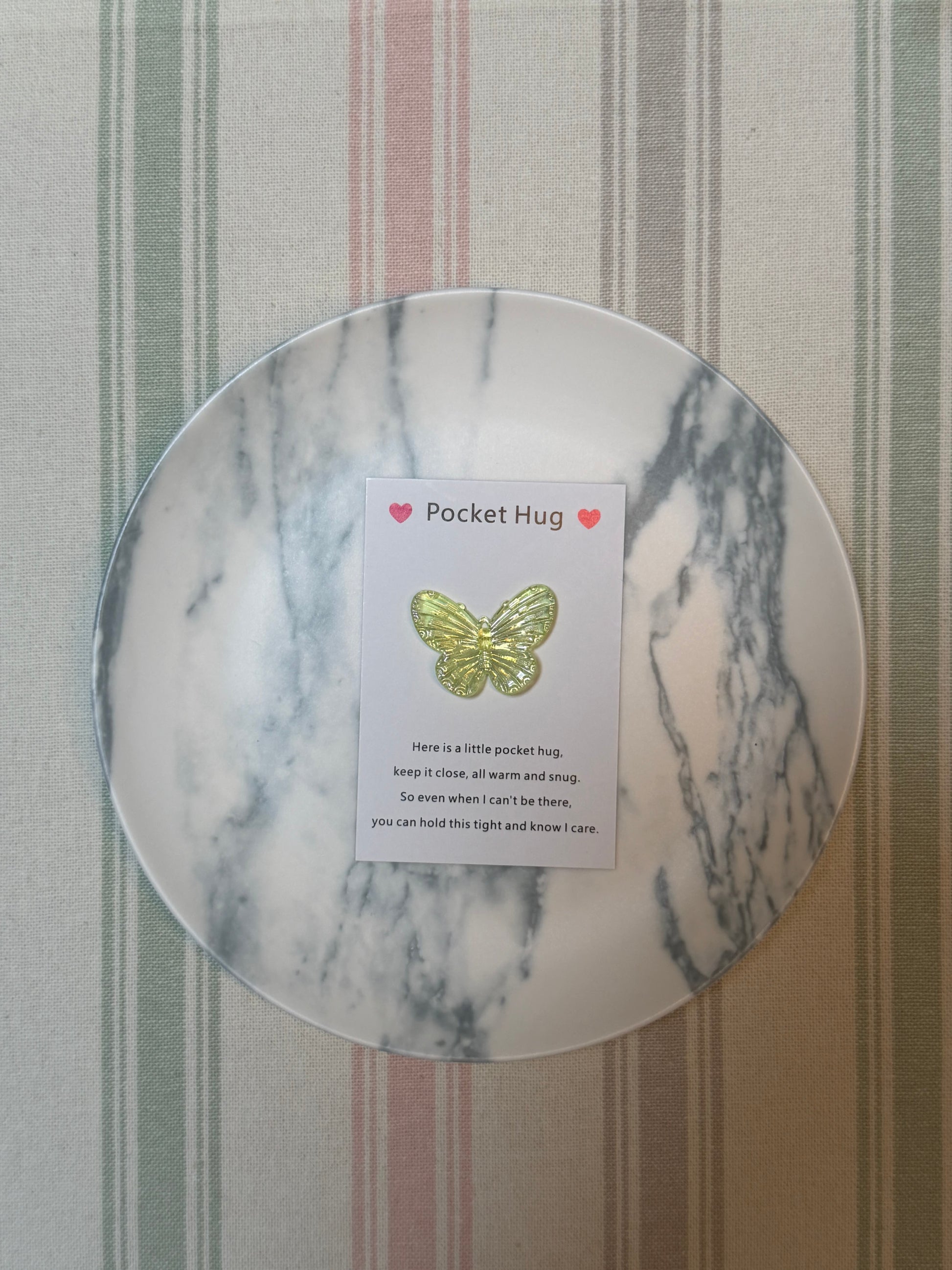 Stack of Taphug Pocket Hug cards highlighting the butterfly motif and compact size