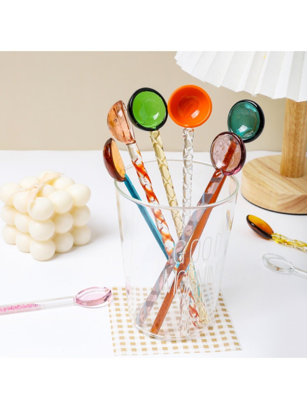 Thimara colorful transparent glass spoon with a pink handle on white background