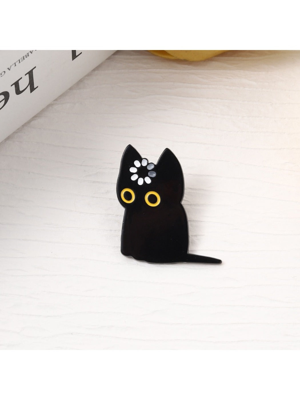 Side view of Pinori black cat brooch highlighting metal pin clasp