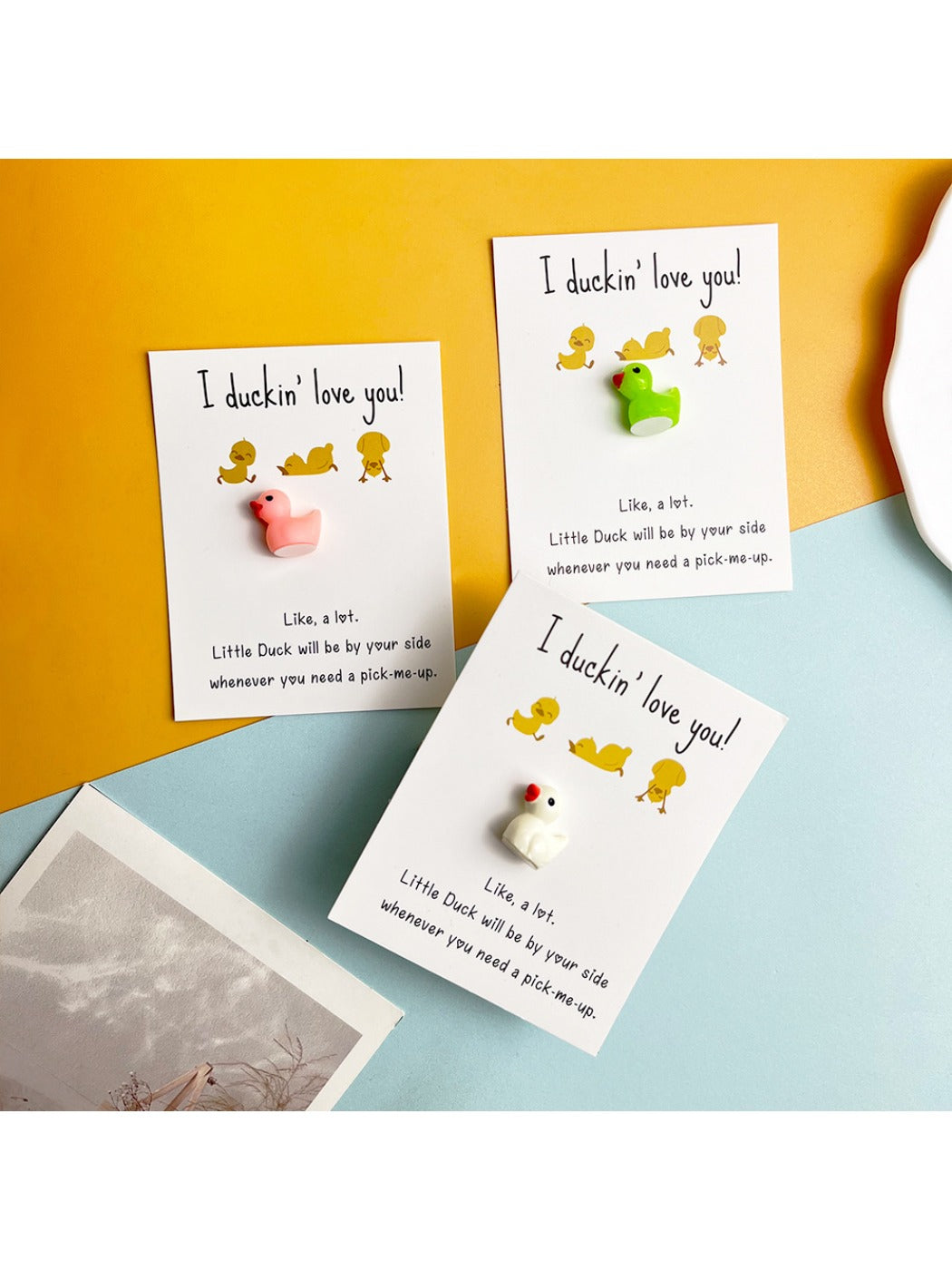 Hand holding the Taphug resin duck pocket hug card showing its compact size