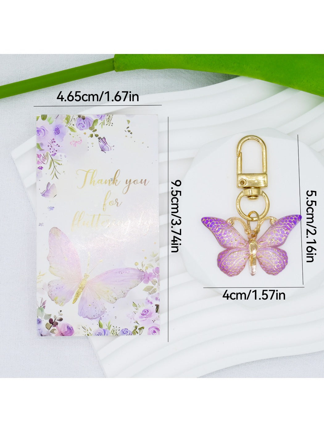 Taphug butterfly keychain with gradient color displayed on a flat surface