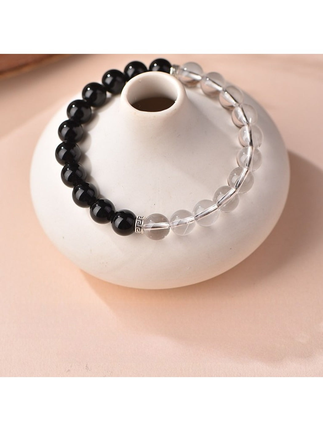 Side angle of Emora black and white bead bracelet emphasizing bead size and finish