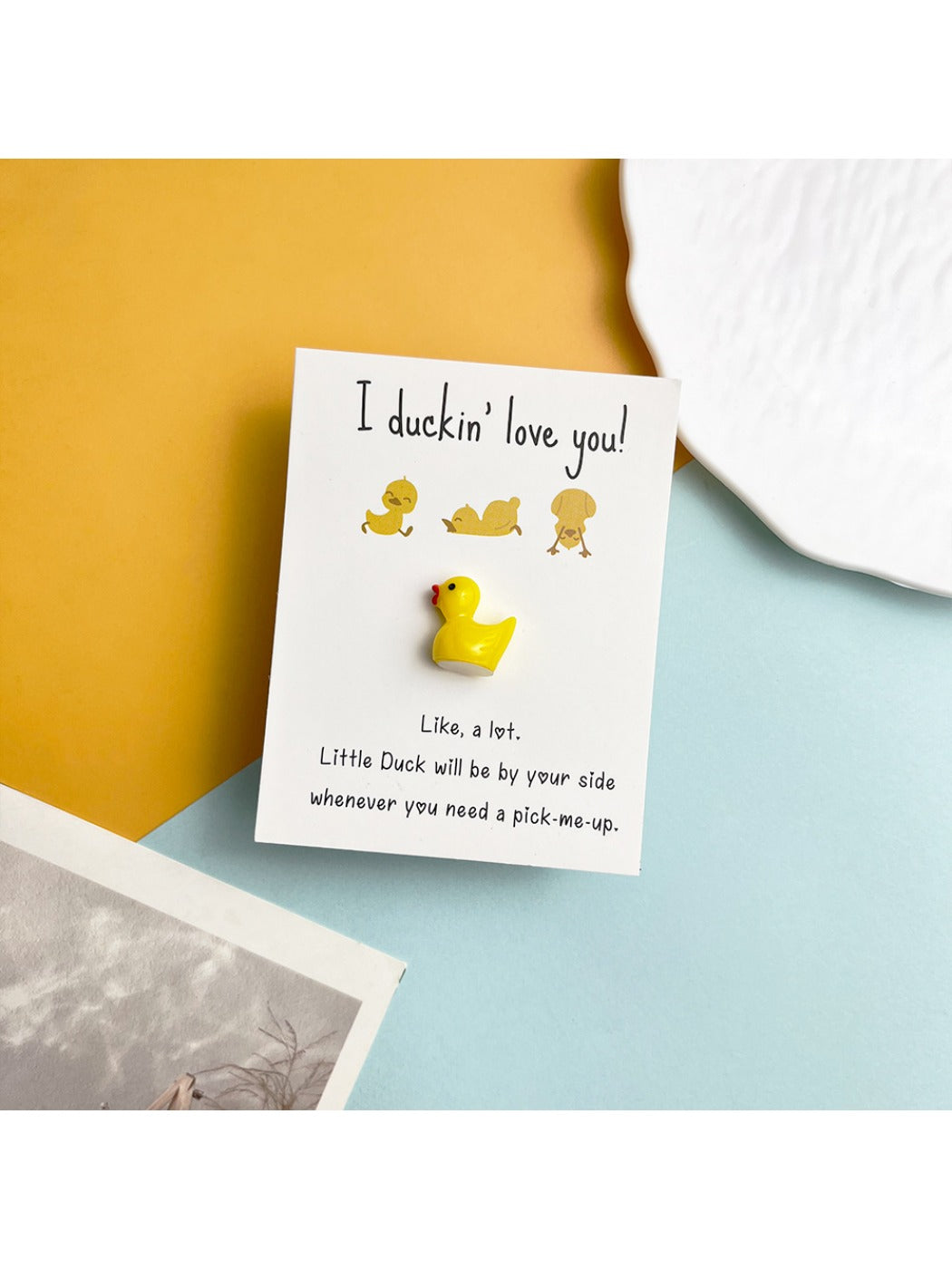 Side view of the resin duck inside the clear pocket hug card