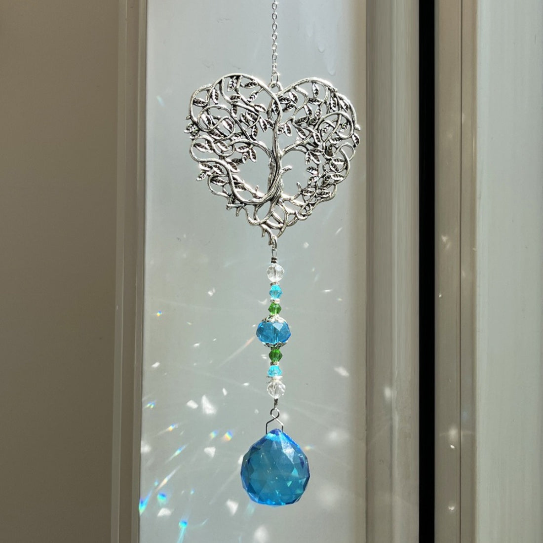 Close-up of Somnira Heart Tree suncatcher showing detailed metal branches and vibrant beads