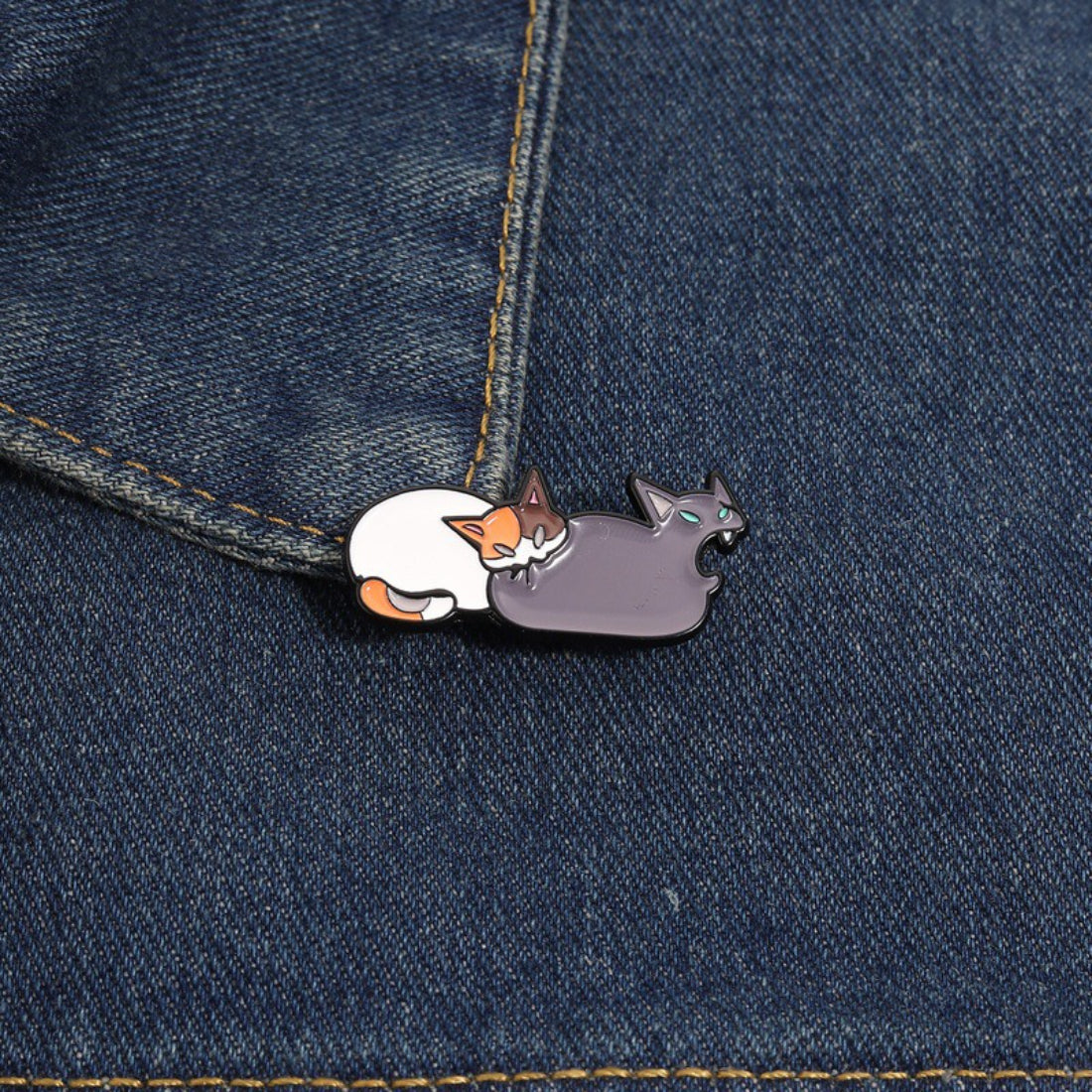 Back view of Pinori cat butt bite enamel pin showing metal pin clasp