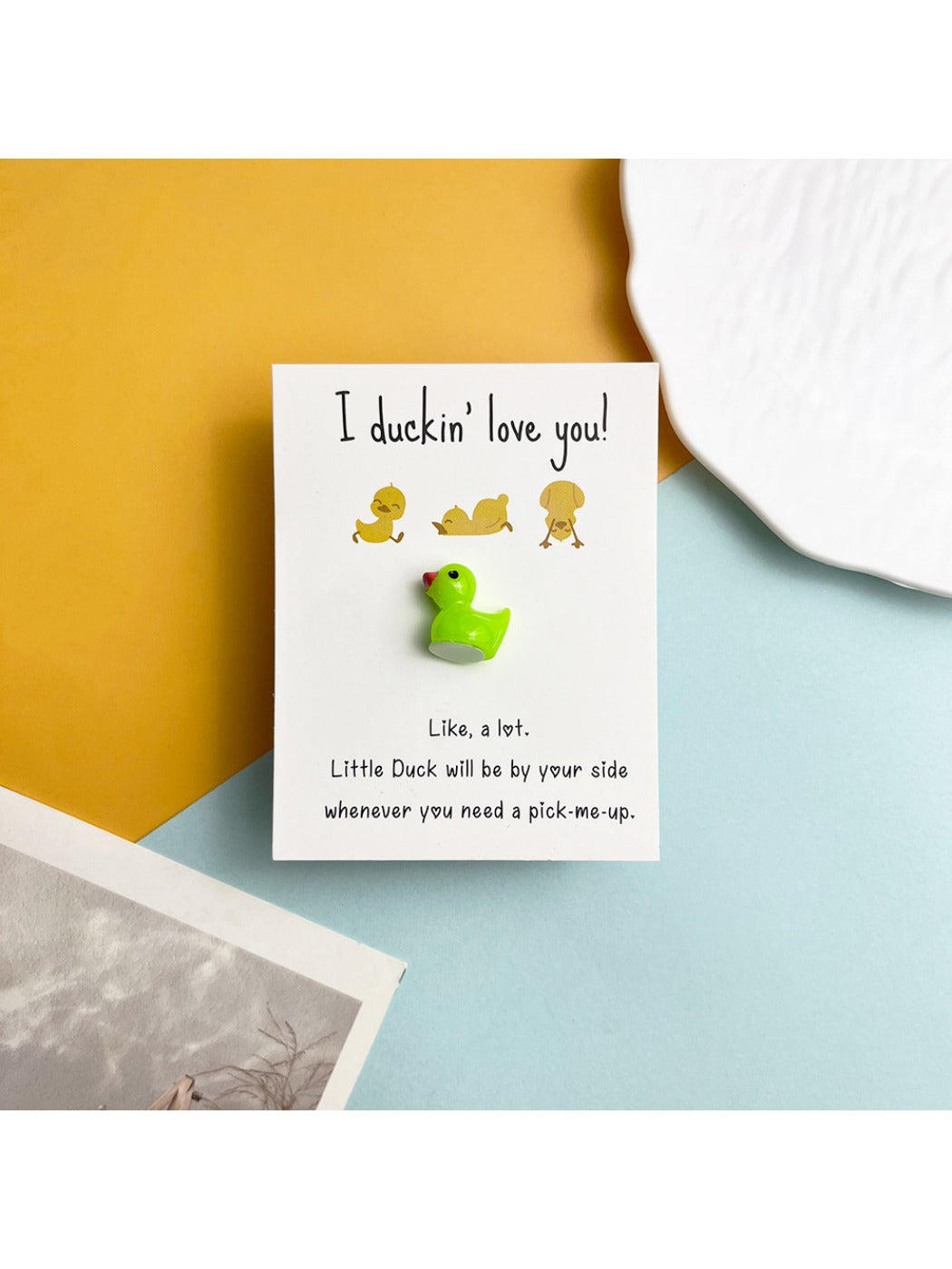 Taphug DIY resin duck pocket hug card next to crafting tools and materials
