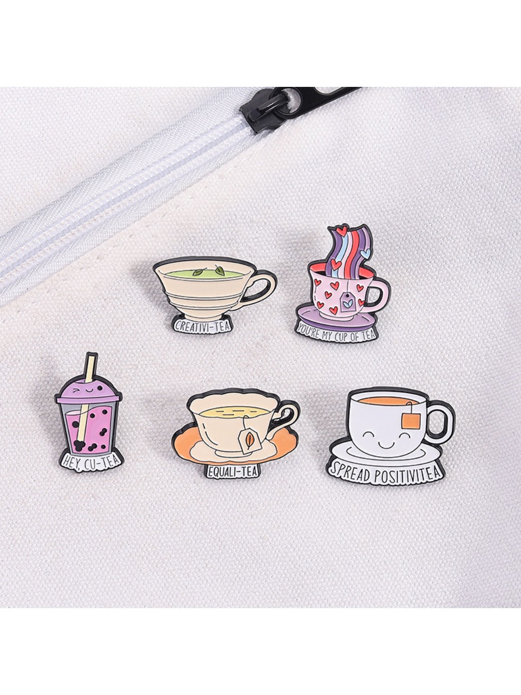 Pinori tea cup pun pin displayed on a corkboard with other pins