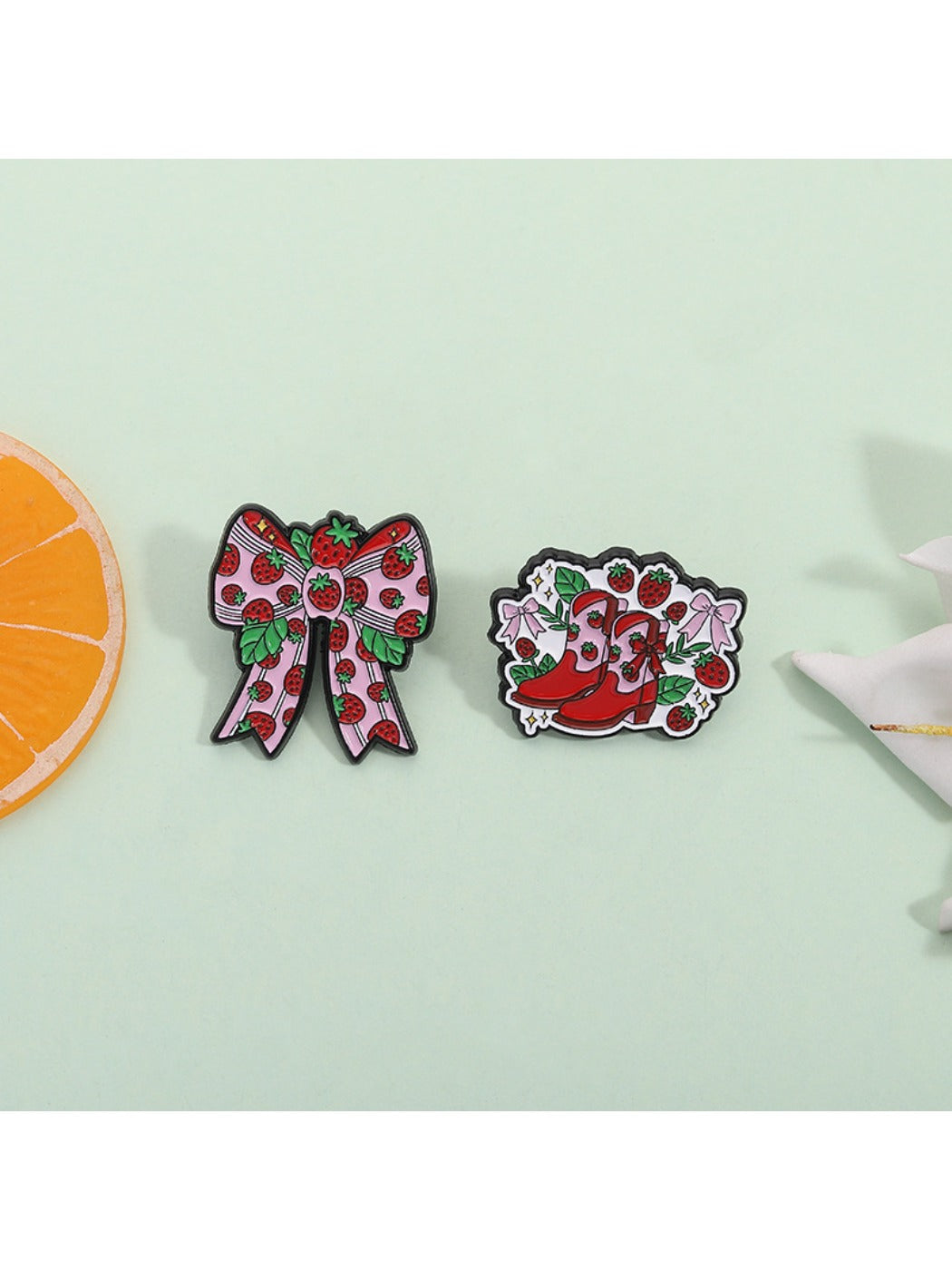 Side view of kawaii strawberry brooch highlighting its glossy finish