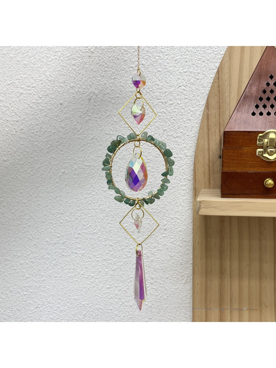 Somnira wind chime displayed against a bright sky with sunlight reflecting on glass