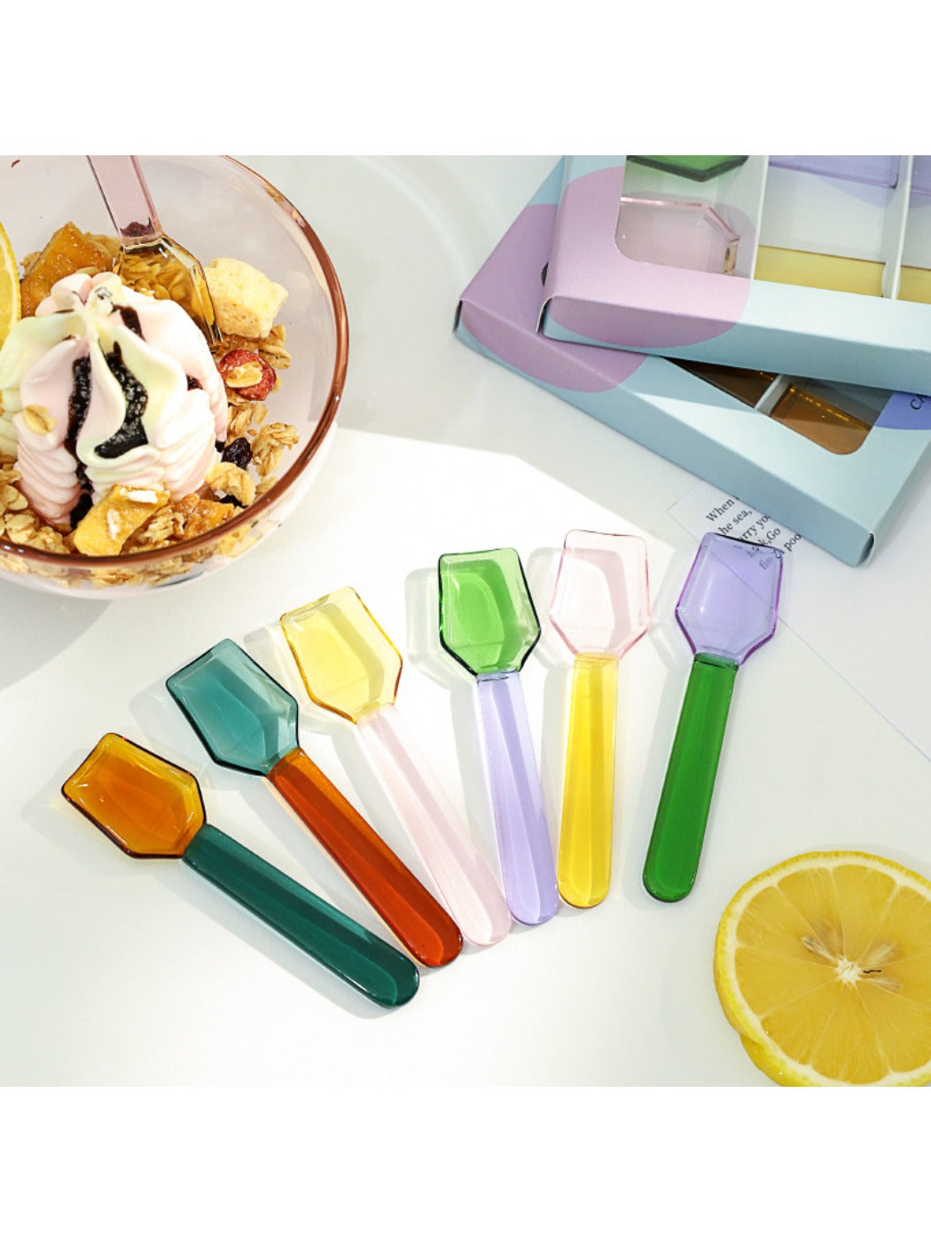 Thimara colorful glass spoon with creative milk dessert design on white background