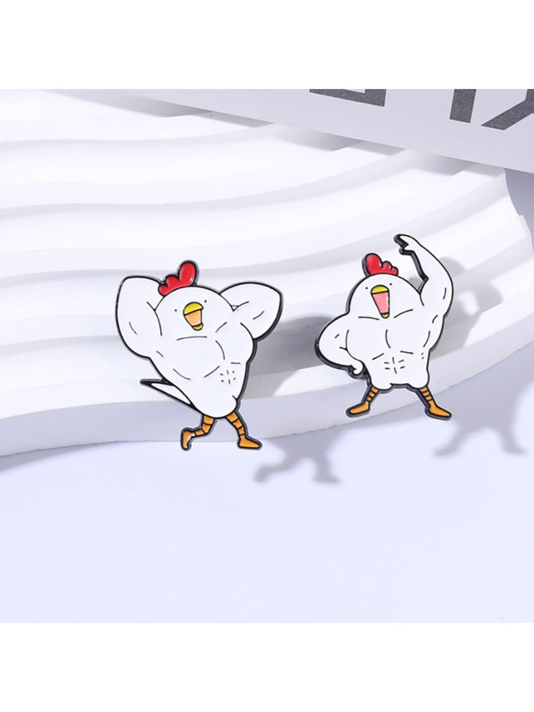 Close-up of Pinori gym chicken brooch with detailed enamel colors