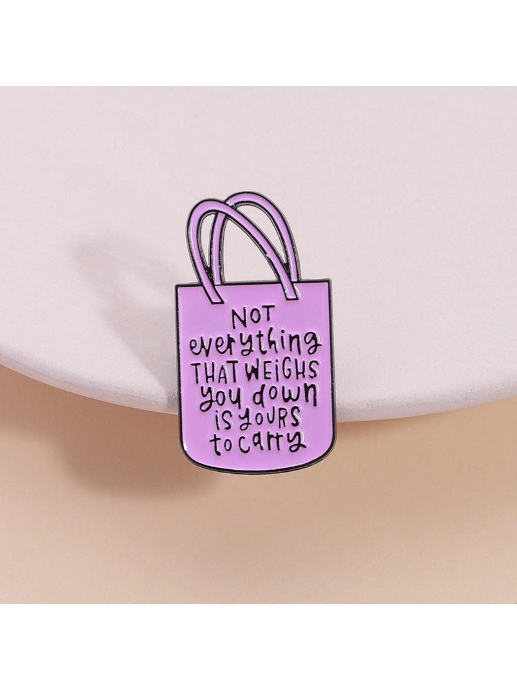 Pinori pink tote bag shaped brooch with gold-tone chain detail on white background