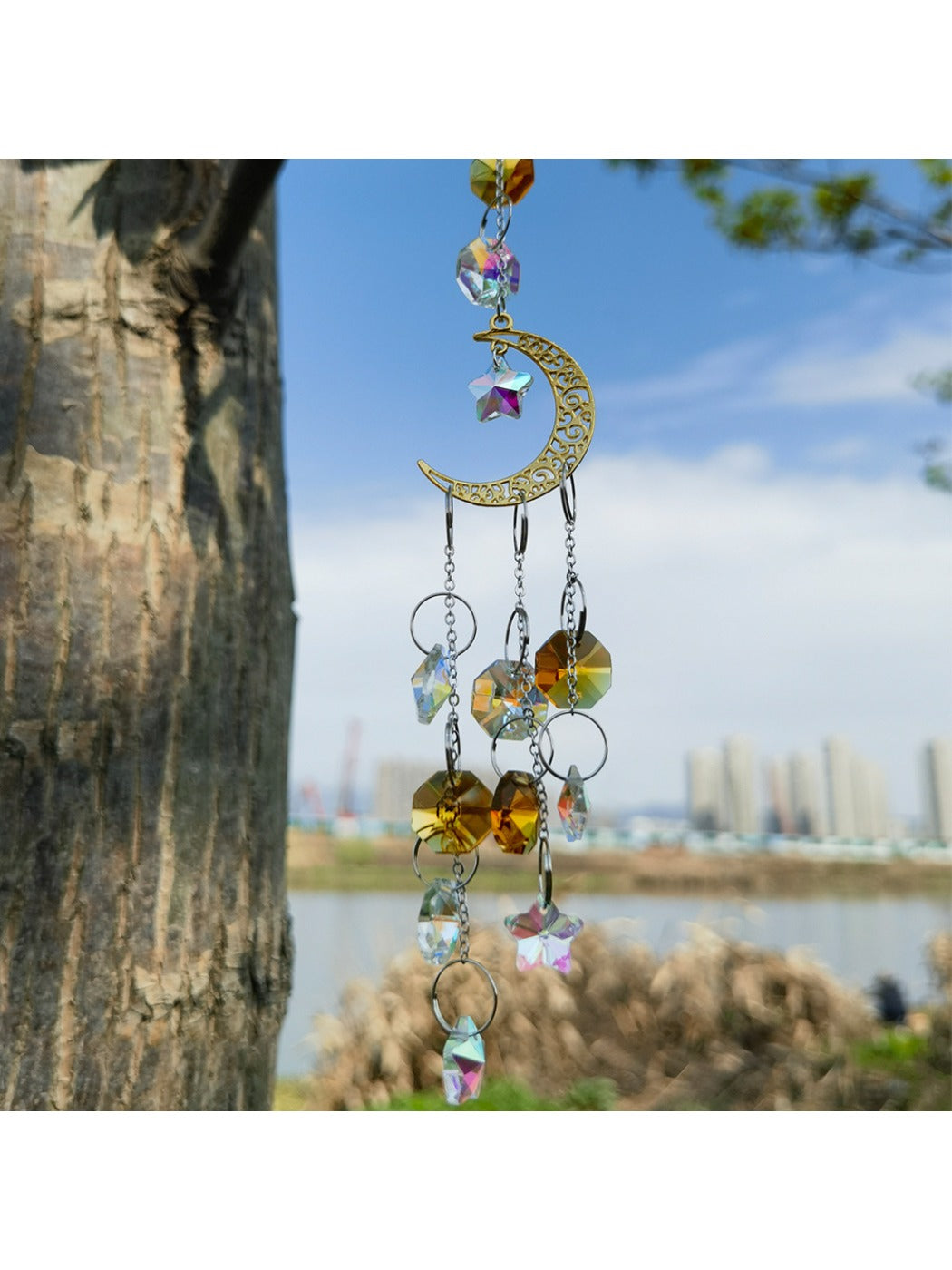 Close-up of golden crescent moon frame with intricate web and crystal details