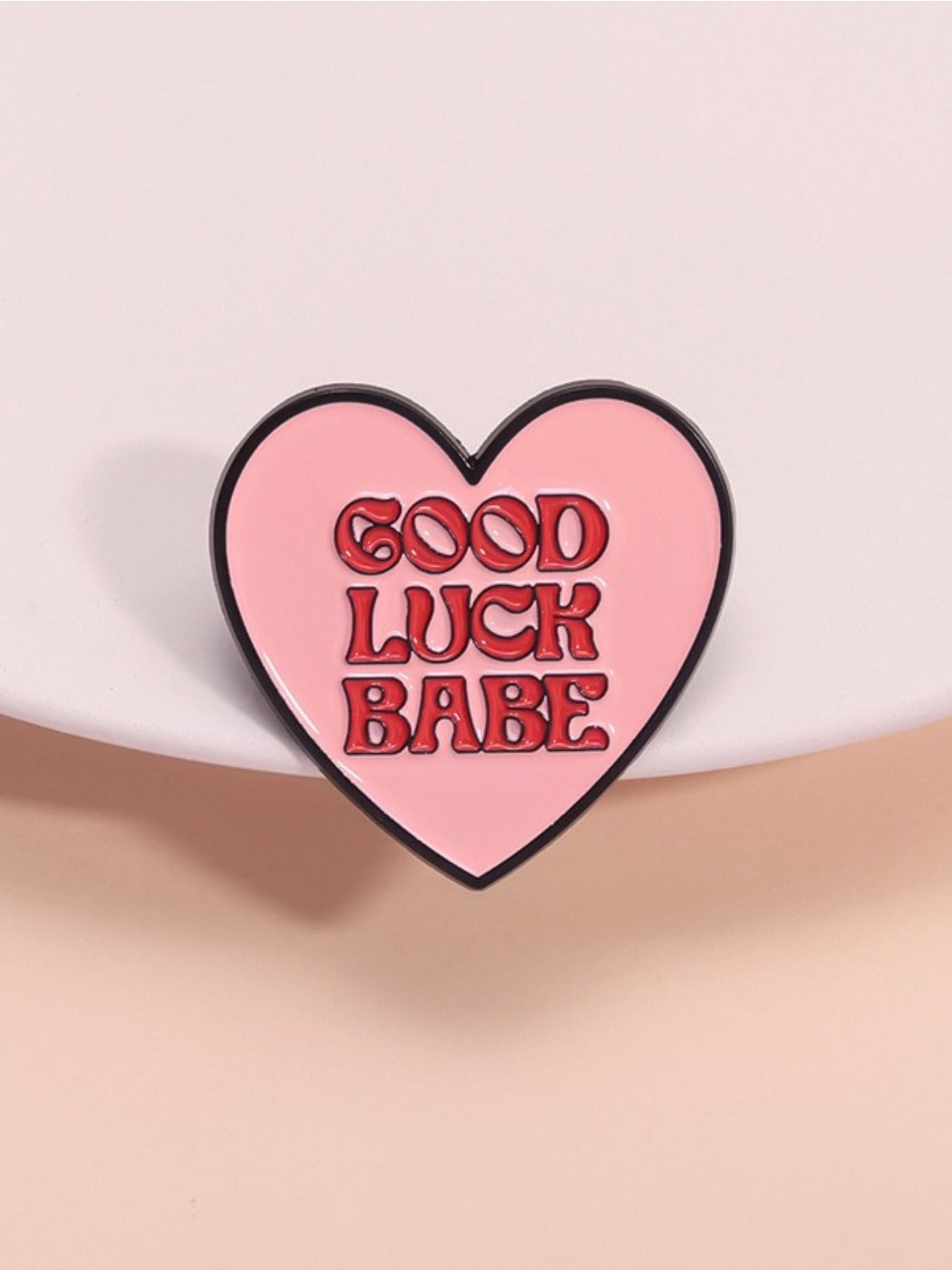 Pinori love heart pin showing colorful wind design and letter detail