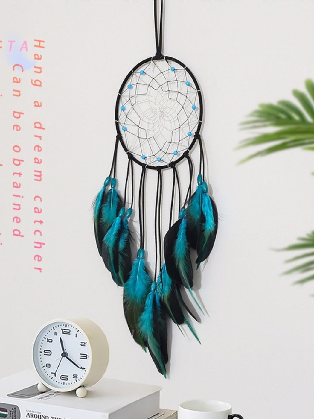 Detailed view of woven web and blue feather accents on dreamcatcher