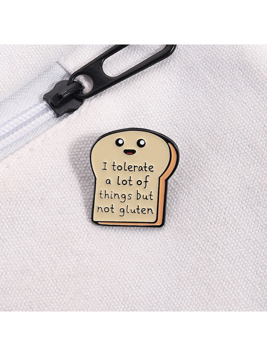 Pinori bread cartoon pin displayed on a black surface