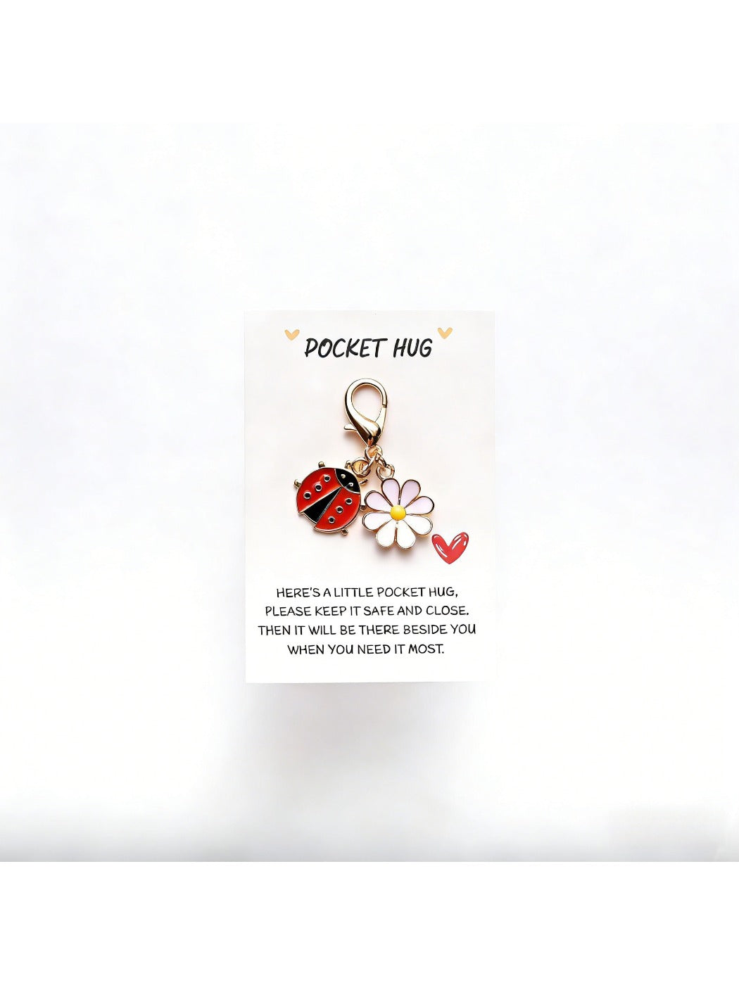 Taphug Pocket Hug Daisy Keychain with white daisy charm and gold ring shown in natural light