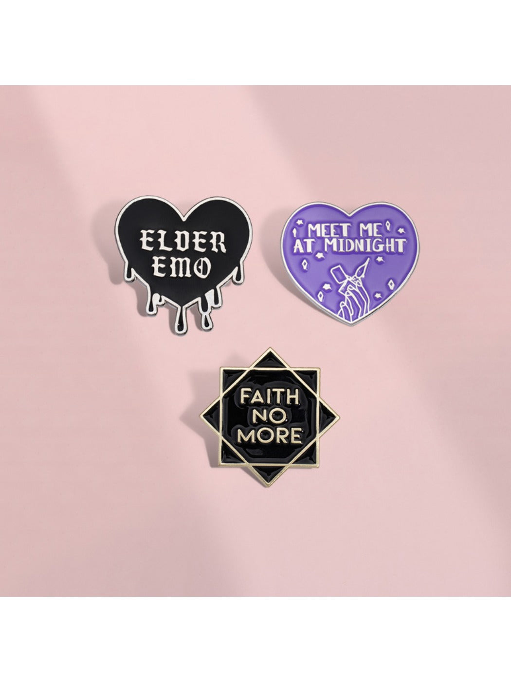 Close-up of Pinori black heart rock band badge showing detailed letter design
