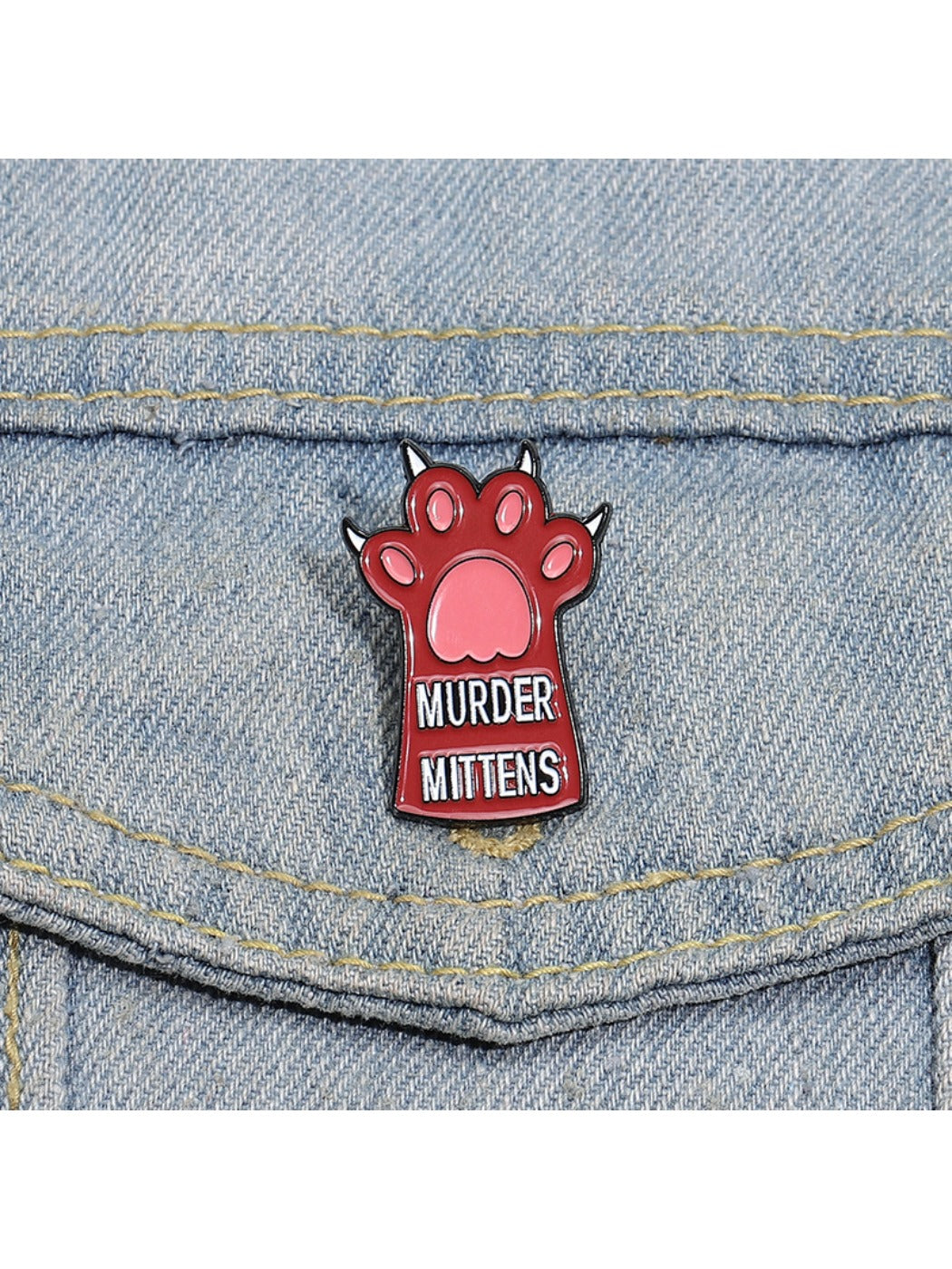 Pinori cute animal paw brooch worn on a denim jacket pocket