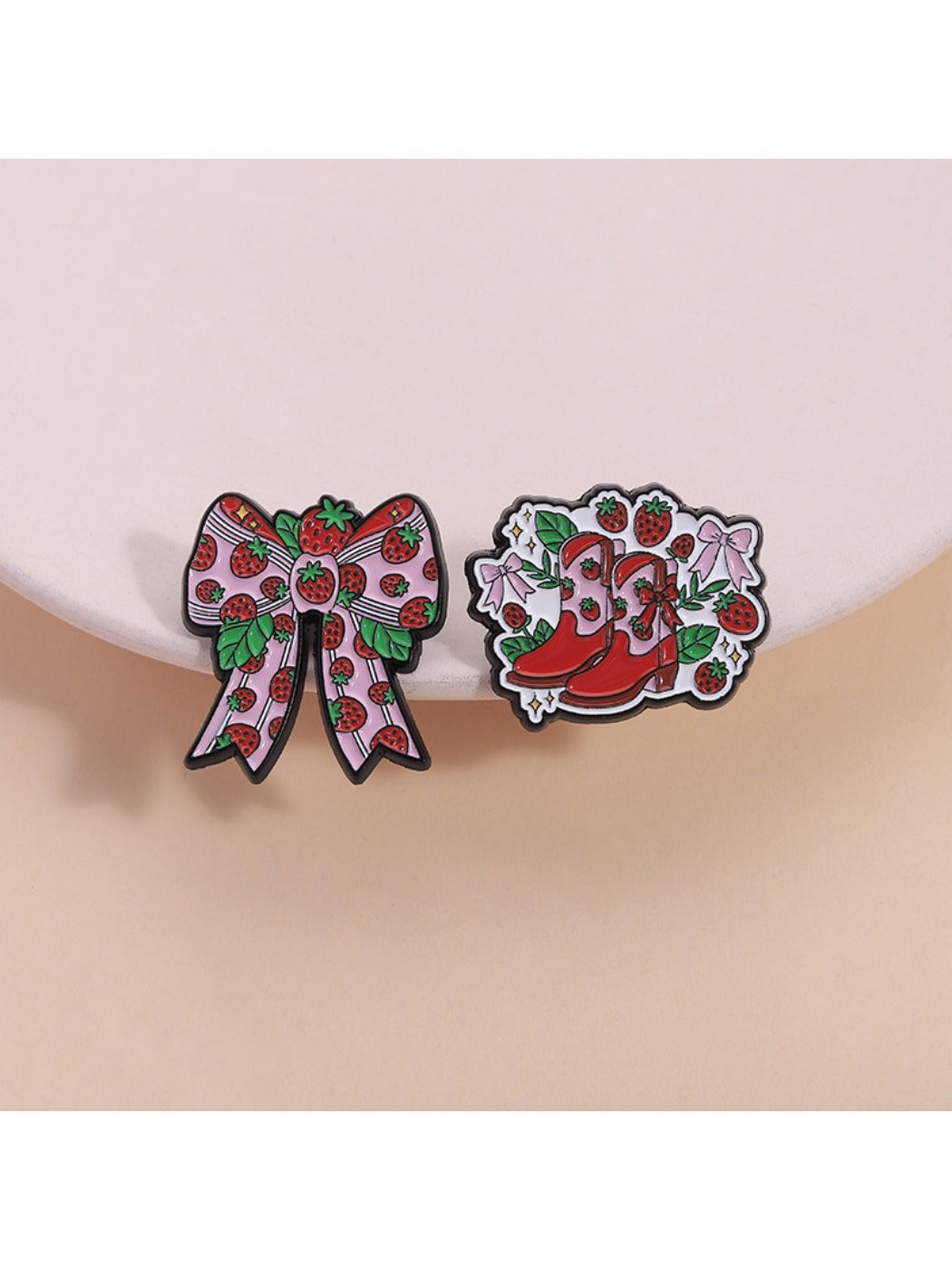 Close-up of Pinori adorable strawberry brooch with kawaii face and green leaves