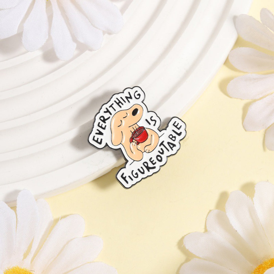 Pinori Figureoutable dog enamel pin with colorful design on white background